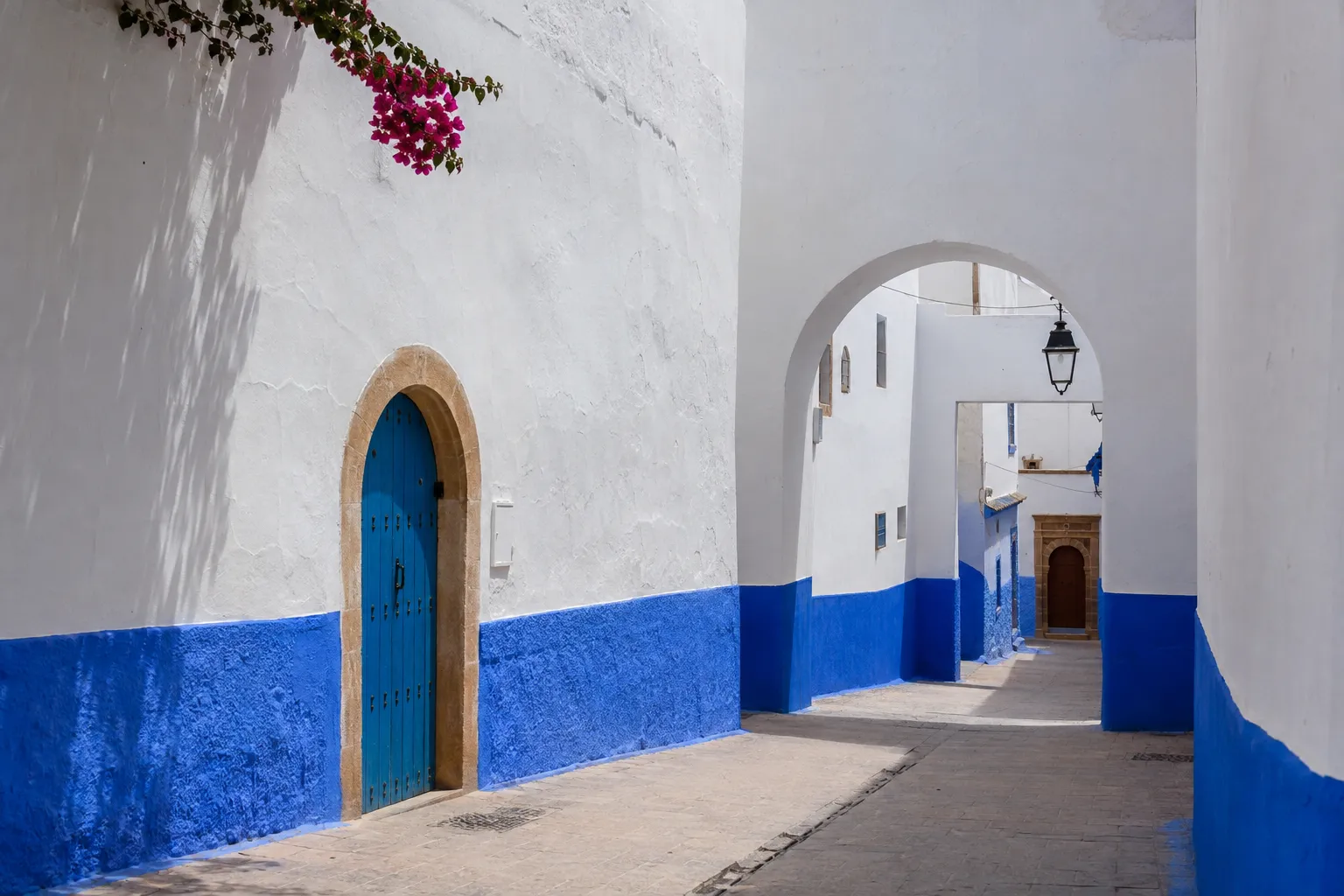 Blue-and-white lane in Rabat's Kasbah of the Udayas during a Marrakech to Chefchaouen journey